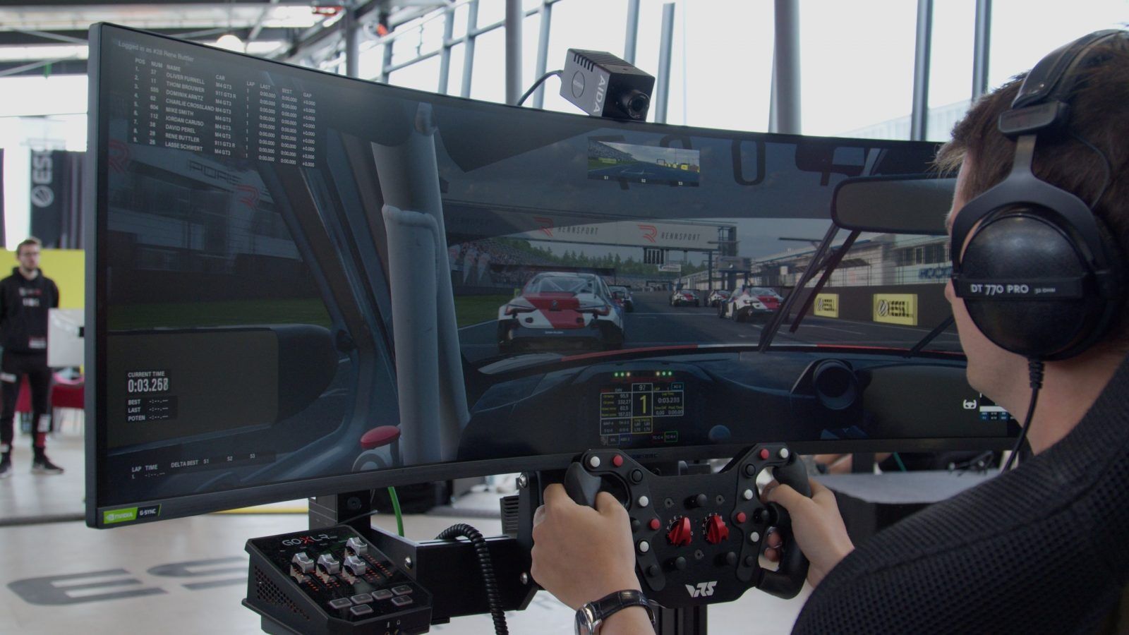 An image of a person playing Rennsport in a sim rig.