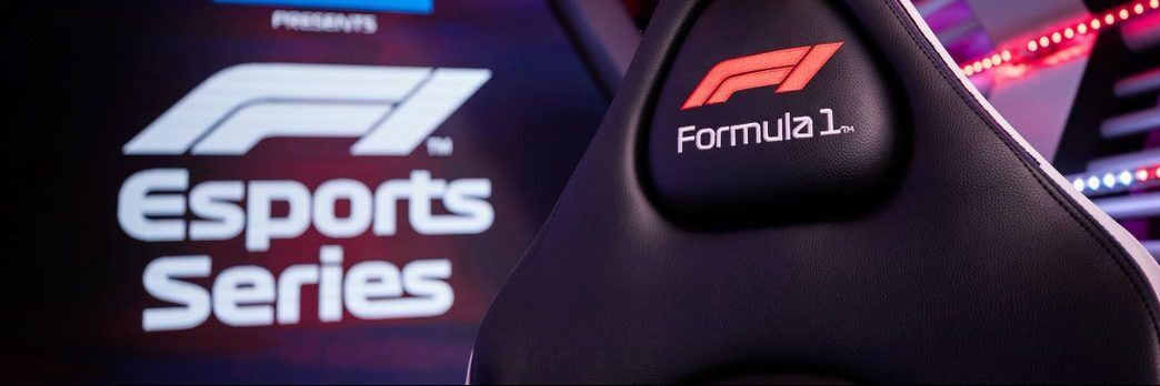 F1 Esports logo in the back of shot with a race seat that has the F1 logo on the headrest.
