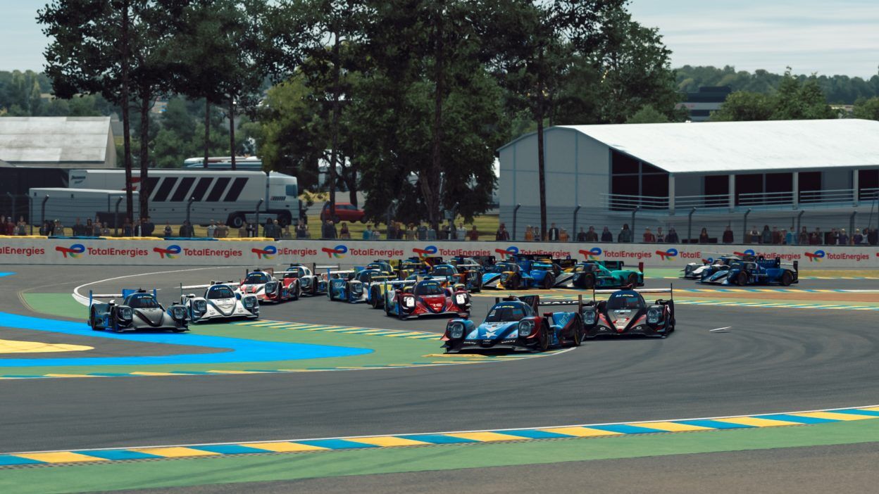 A large group of LMP2 cars navigating the Dunlop chicane.