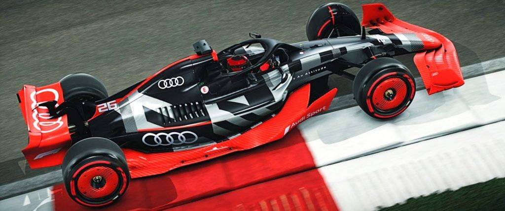 An F1 car decked in Audi colours, dark grey with a red base and red rims.