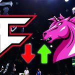 A backdrop of drivers standing around a load of racing sim rigs, with the logos for FaZe Clan and Unicorns of Love with a red arrow pointing down next to FaZe and a green arrow pointing up next to UOL.