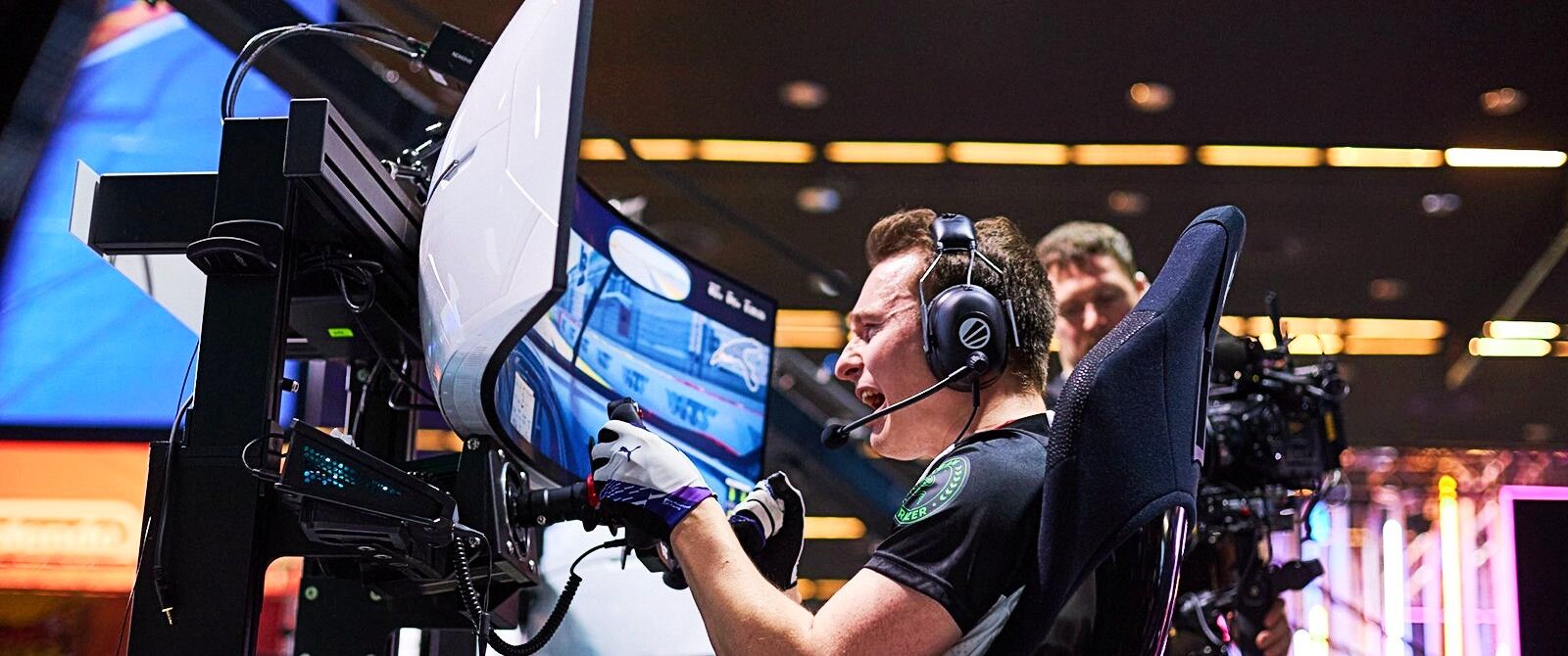 An image of Max Benecke celebrating in his sim rig at the ESL R1 event in Katowice.