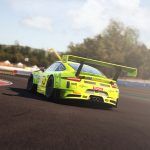 lime green gt 3 car seen from behind going through a left hand corner on a race track