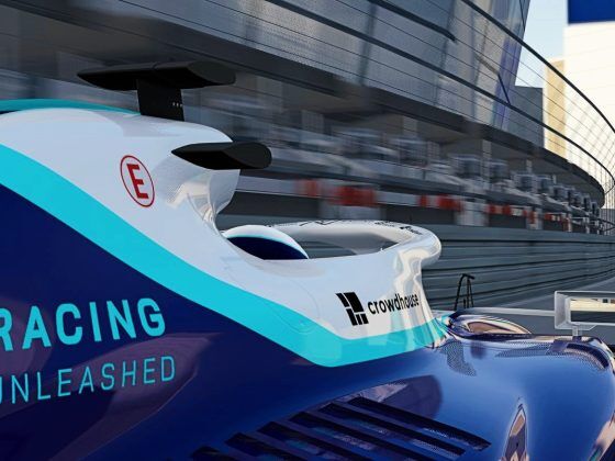 A close up of an F1 car with the Racing Unleashed logo on the side. It is navigating its way around an airport terminal.