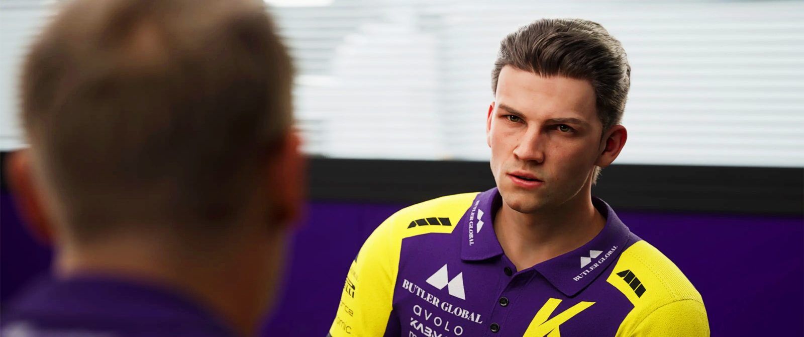 A man wearing a purple and yellow polo shirt.