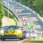 A collection of Porsche 992 GT3 Cup cars heading towards Flugplatz on the Nordschleife.