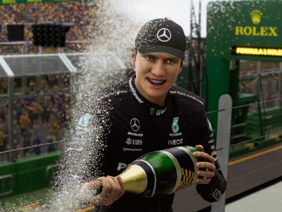 A guy in Mercedes overalls spraying champagne overlooking a racetrack.