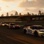 A twilight tracking shot of GT3 cars going through shot at speed.