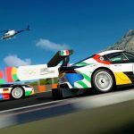 Two Toyota Supra racecars in Olympic colours, one with an Italian flag and one with a German flag.
