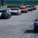 A line of 12 GT3 cars on a grid, each in different colour schemes