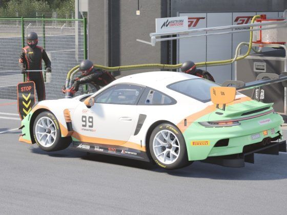 A Porsche racecar in the OverTake colours white, teal and orange.