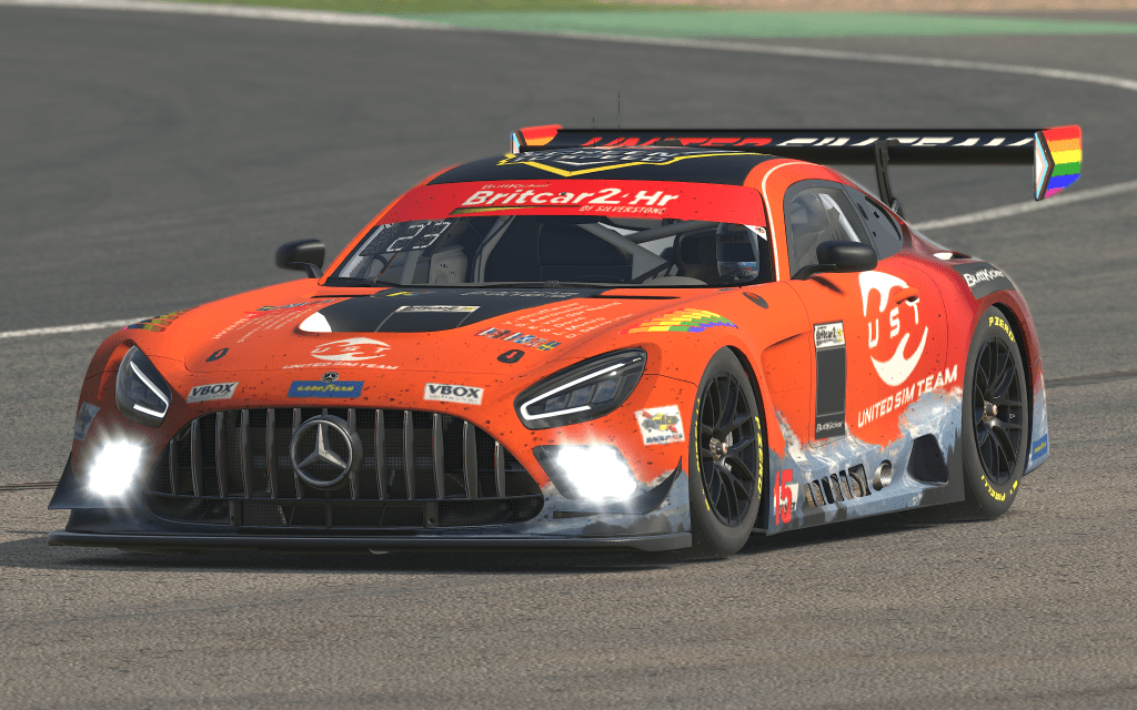 A bright orange and dark red Mercedes AMG GT3 with mountains on the side.