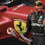 Lewis Hamilton with trophy in front of a Ferrari SF-23